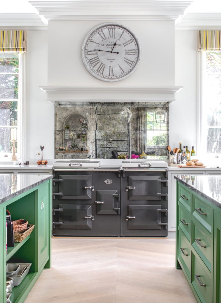 Two green kitchen islands and a kitchen clock