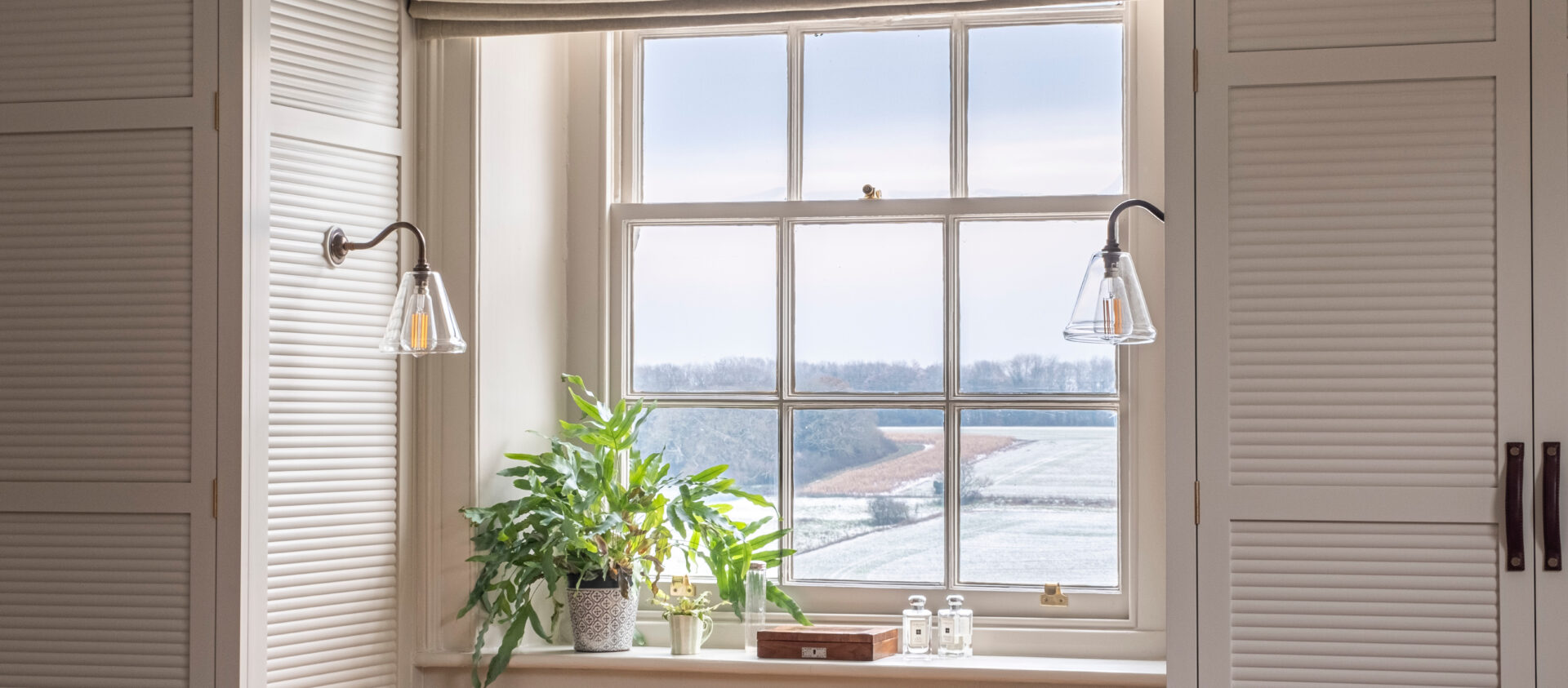 View through a window to a snow covered field