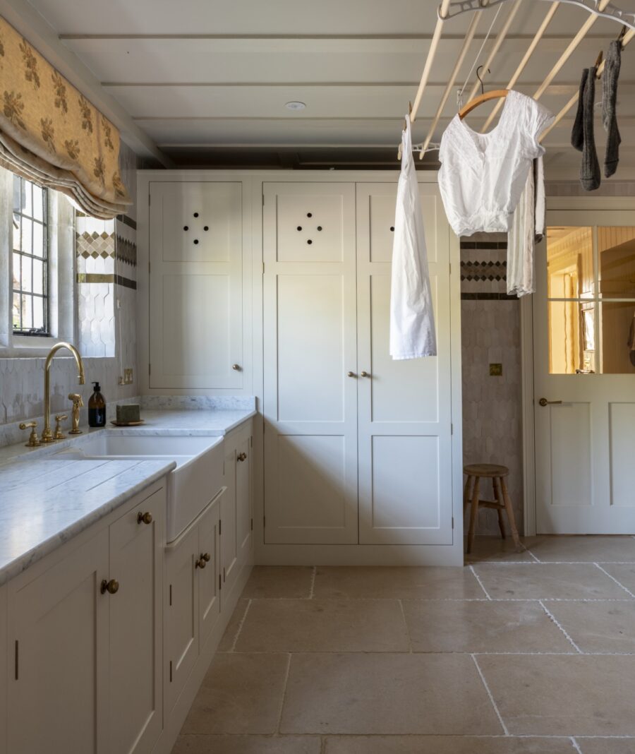 Laundry room with large storage cupboard at the end