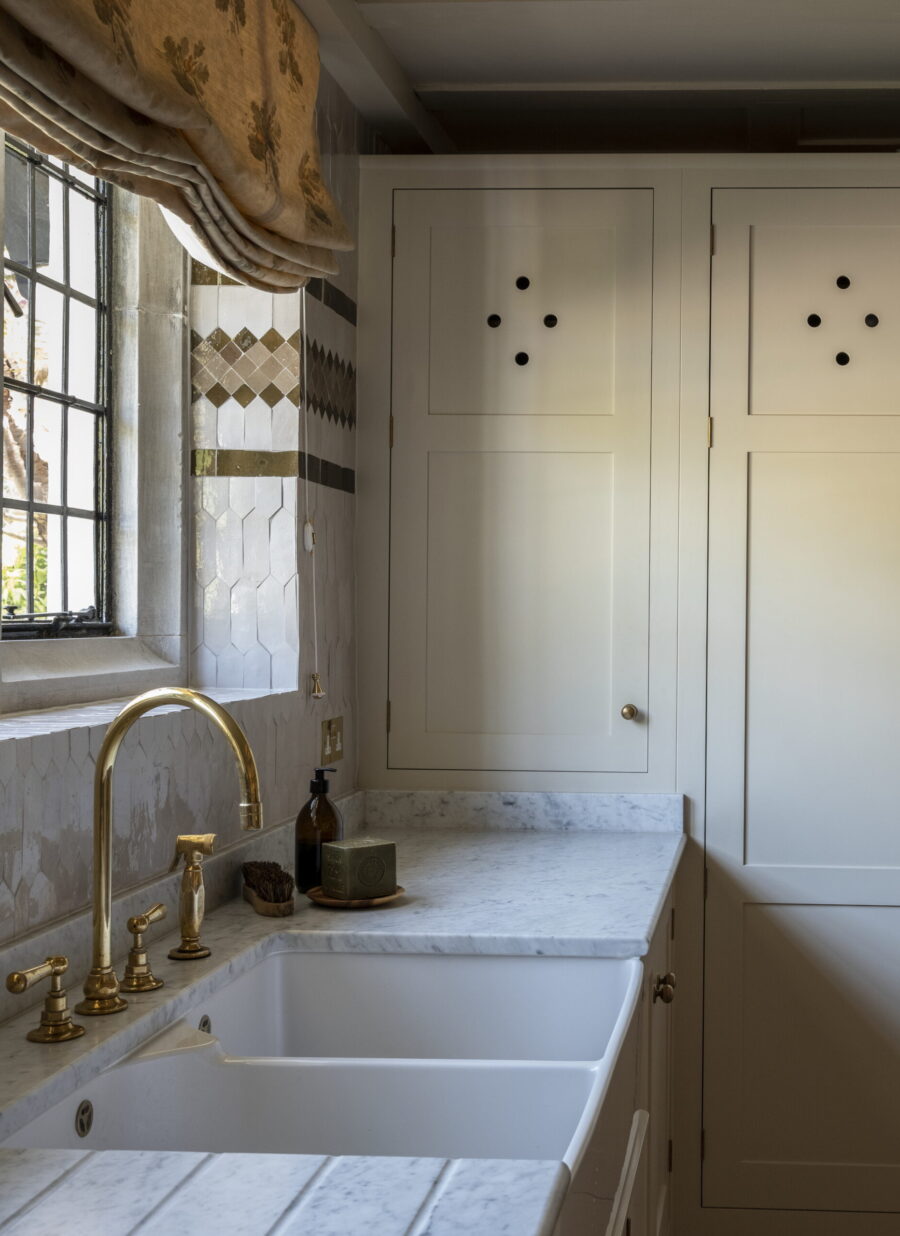 The laundry sink area set into marble worktops