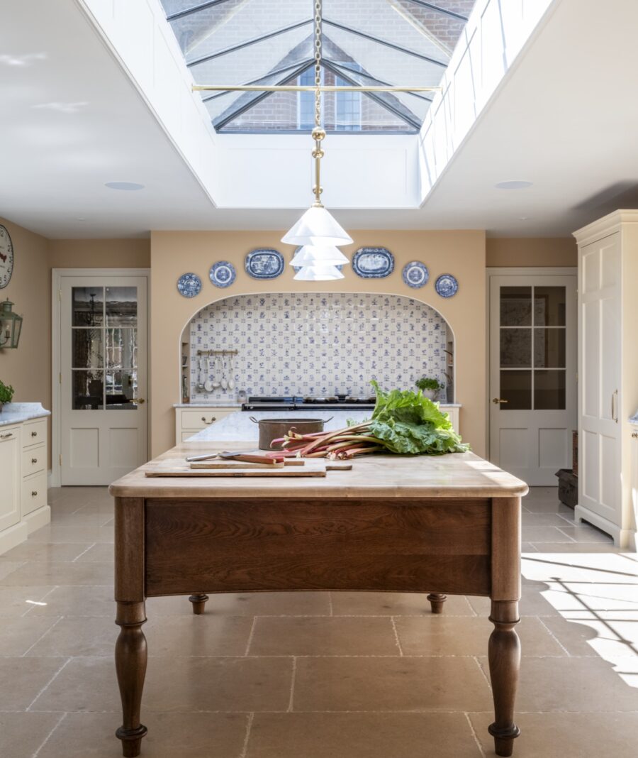 Cooks table with neutral coloured walls offer traditional colours for a country house kitchen